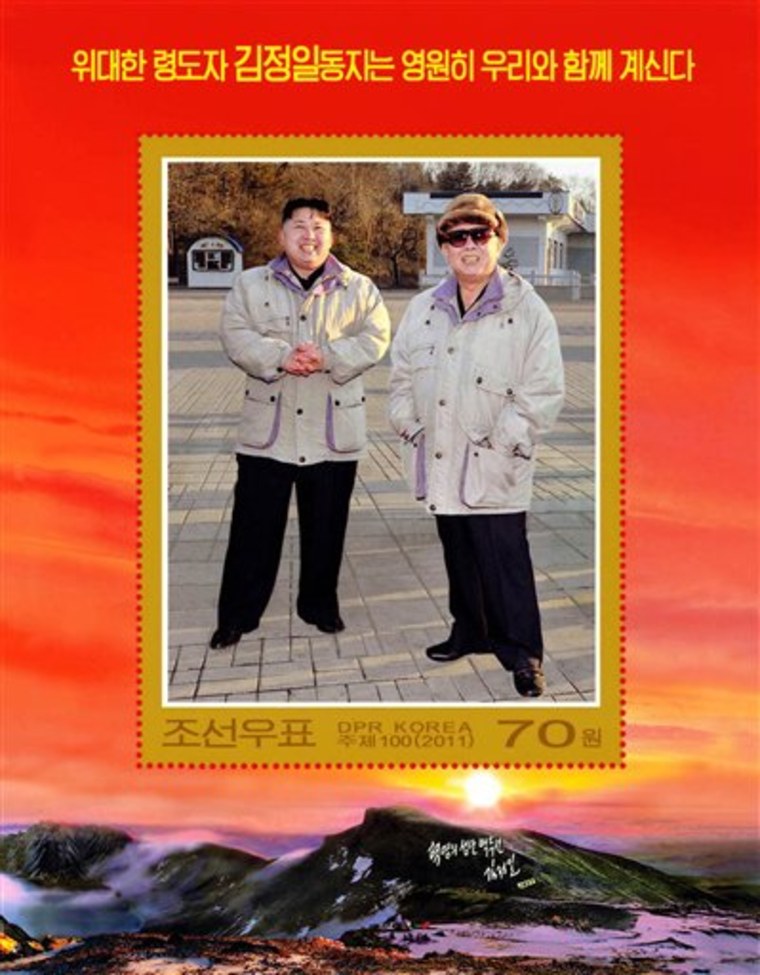 In this undated photo released by the Korean Central News Agency and distributed in Tokyo by the Korea News Service on Friday, a commemorative postage stamp featuring late North Korean leader Kim Jong Il and his son Kim Jong Un is shown. The words on the top read "The great leader comrade Kim Jong Il will always be with us."